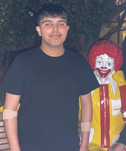 Alex smiling with Ronald bench in the background.