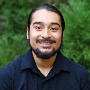 Adrian Padilla 400p Man in black shirt smiling at camera