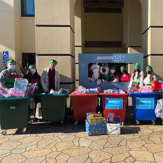 A community group stops by during the holidays to donate items for the Comfort & Joy drive
