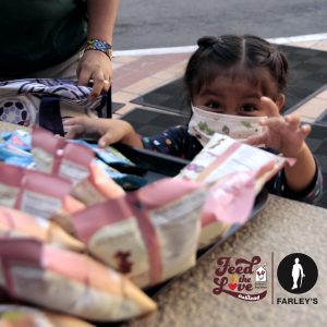 young girl reaching for snack