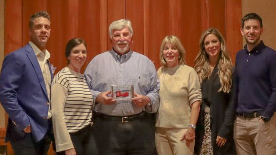 The Lamson family joined Scott as he was honored with the Big Red Shoe Award. Alongside him are his wife, Karen Lamson (nearest right), Greg Sinigiani (far left), current RMHC board member, and siblings.
