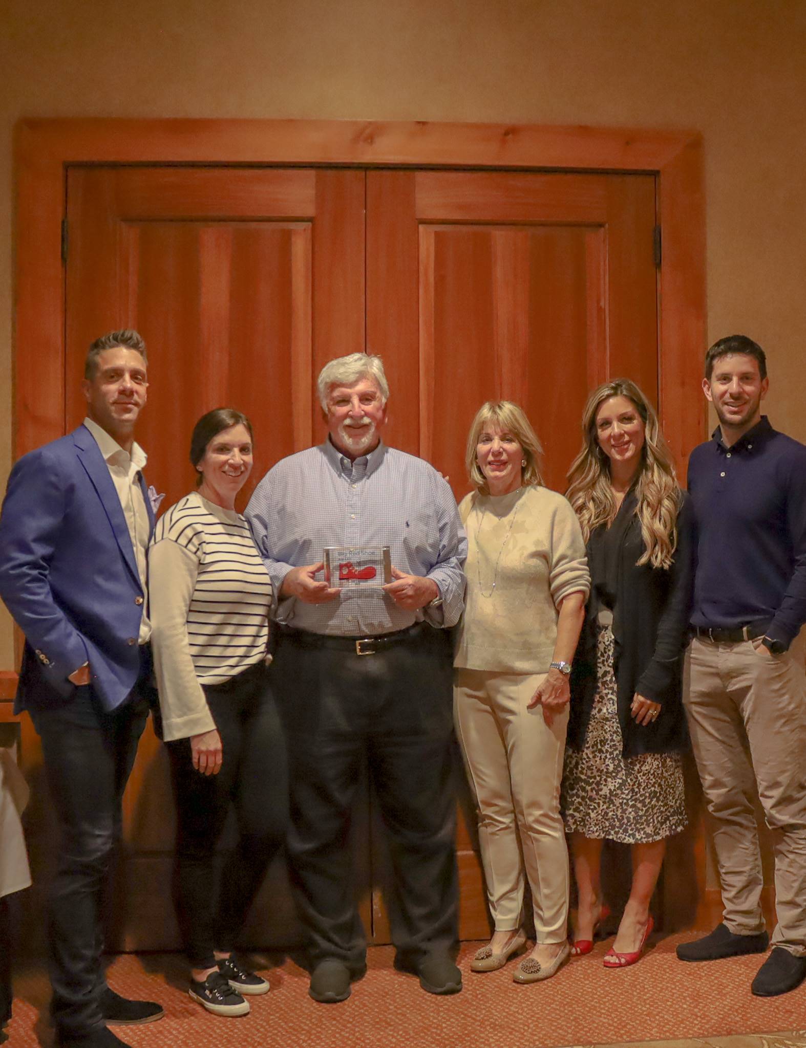 The Lamson family joined Scott as he was honored with the Big Red Shoe Award. Alongside him are his wife, Karen Lamson (nearest right), Greg Sinigiani (far left), current RMHC board member, and siblings.