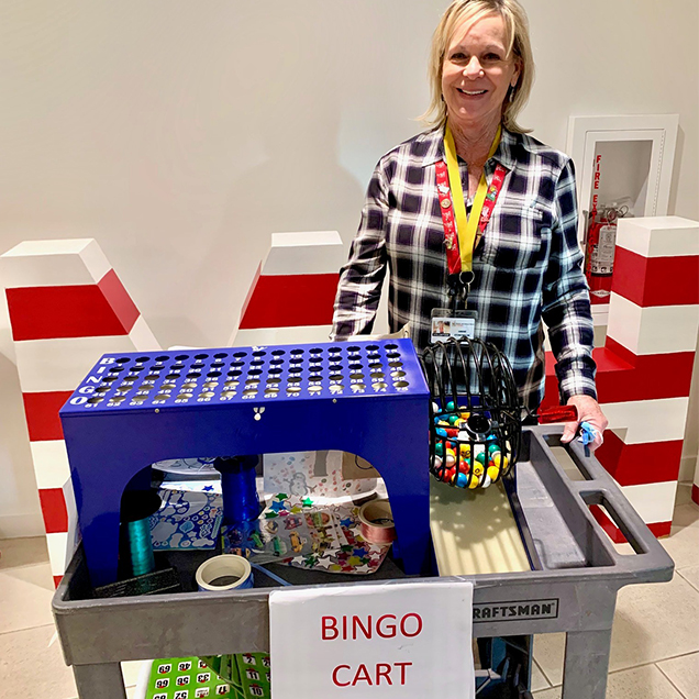 Janice e Bingo Cart: A Special Interest volunteer with the RMHC bingo night cart and supplies