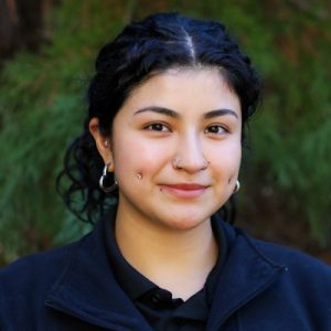 Jethsamany Pelcastre 400p Woman in black shirt smiling at camera