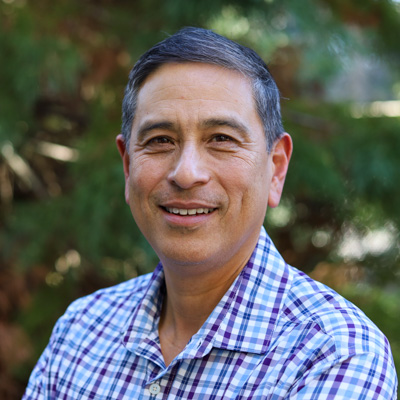 Man in blue shirt smiling