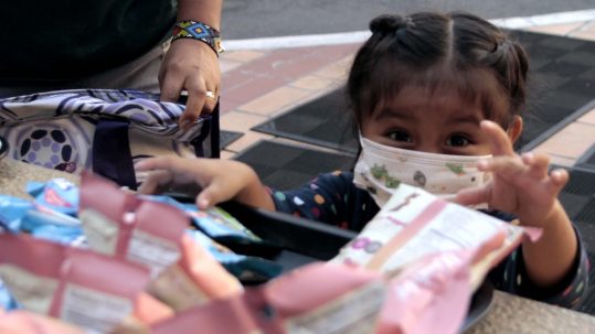 Silbing at Oakland Children's reaches for snacks