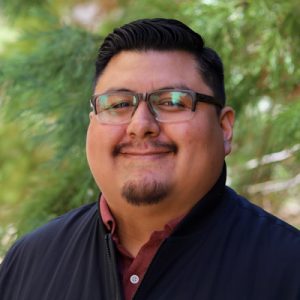 Luis Norberto 400p Man with glasses and black shirt smiling at camera