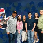 The Medina Flores family poses in front of a blue and yellow balloon backdrop with inset photos highlighting CHD awareness.