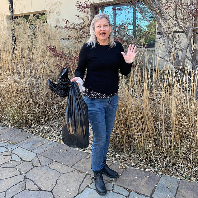 Melissa Trash pickup: A Team Volunteer helping pick up trash outside.