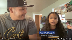 Young girl named Kaiya Mack speaks during a video segment, seated beside a man wearing a Cal shirt, with kaiyamack.com shown on screen.