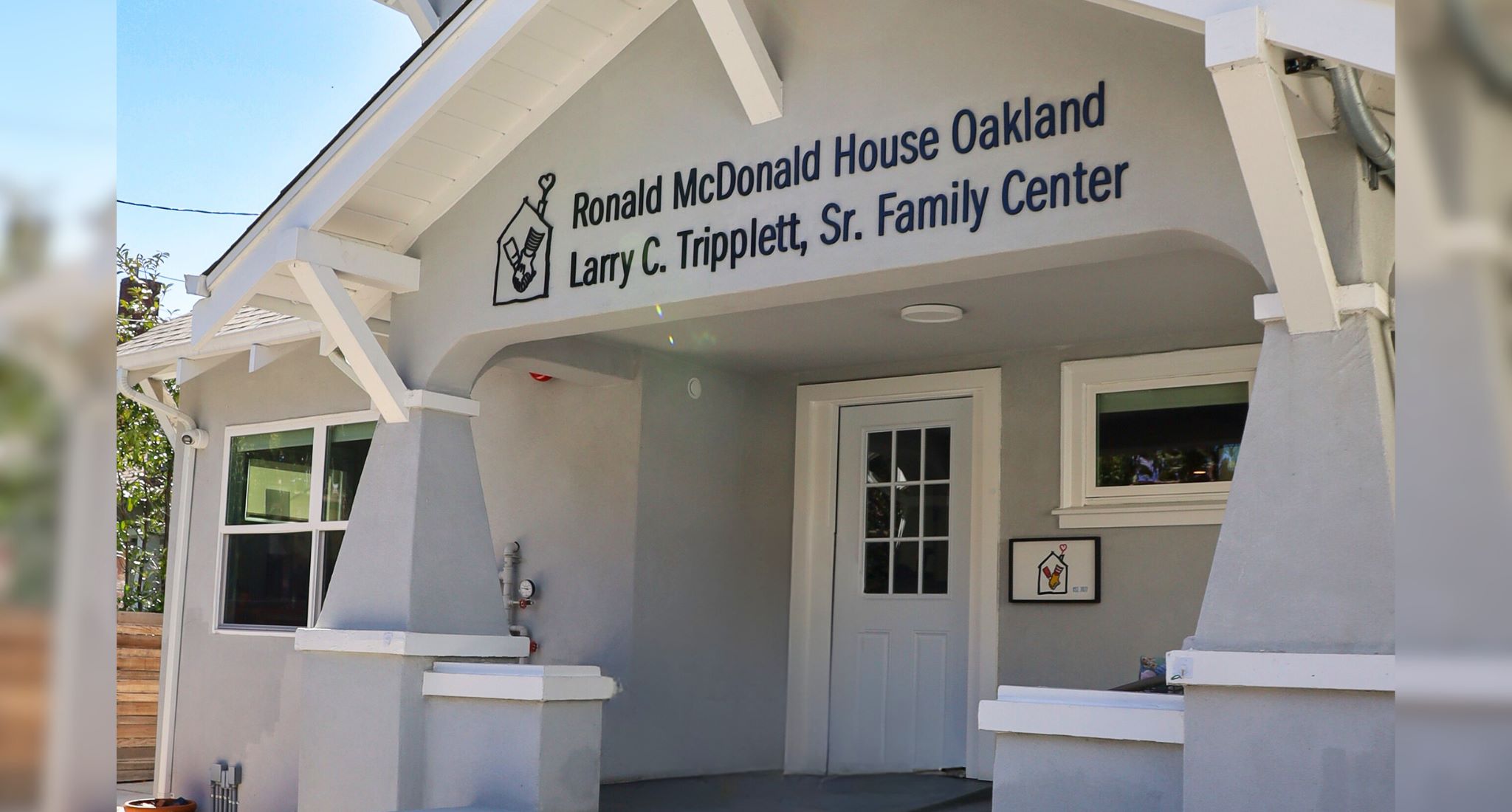 Oakland House BANNER IMG Image of the front of a building with Ronald McDonald House Oakland Larry C. Tripplett Sr. Family Center engraved.