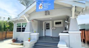 Front view of the Ronald McDonald House Oakland with a blue banner above the entrance.