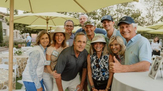a group of donors including Brad are smiling at an event