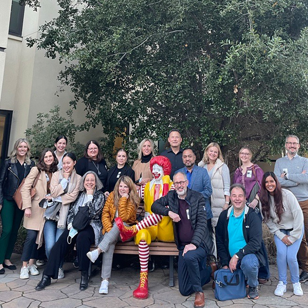 Volunteer group, Varian, posing with Ronald after assembling care kits.