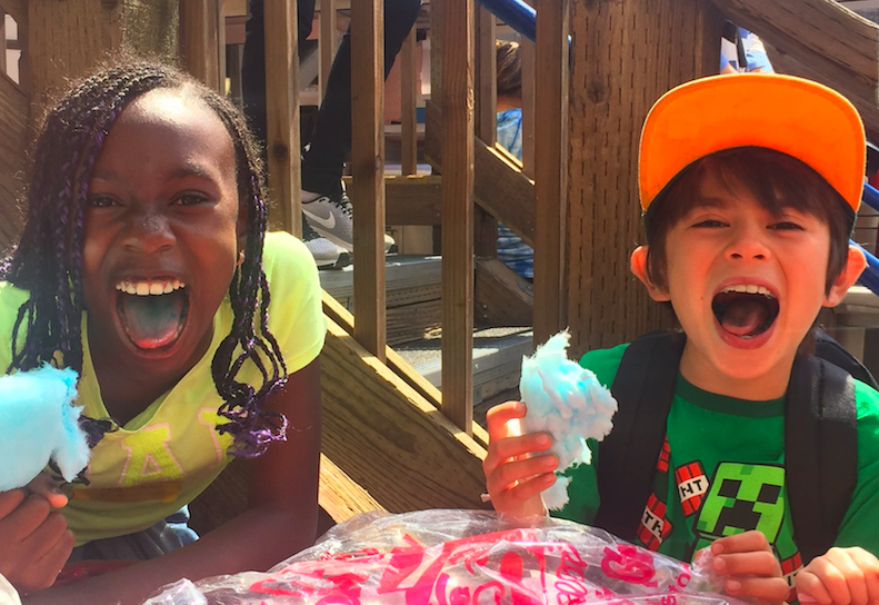 sibling_camp Two kids act silly while holding cotton candy at Siblings Camp